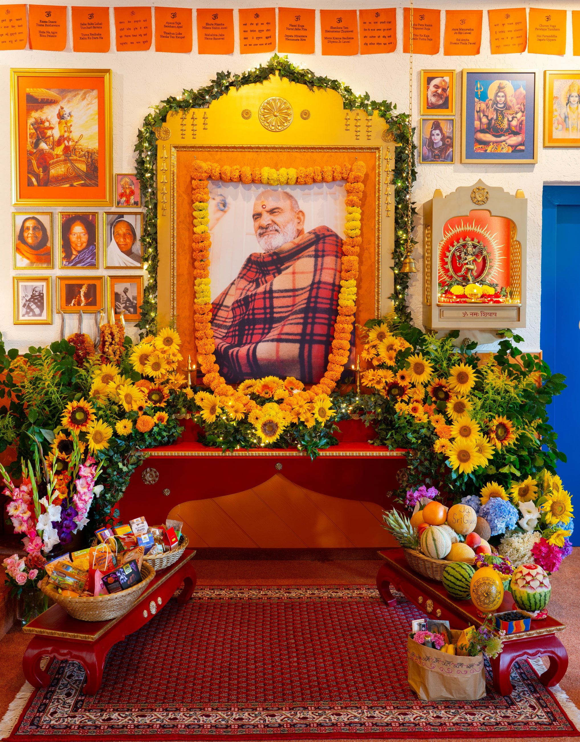 sumptuously decorated picture of Maharajji Sri Neem Karoli Baba